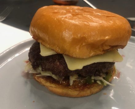 BBQ Burger with Caramelized Onions, Slaw, Roasted Jalapeño Relish, and Habanero-Chipotle Hot Sauce